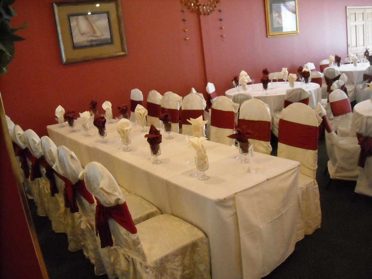 Head table set with burgundy sashes for a banquet at Taste of India, Willowbrook IL